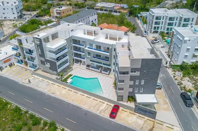 an aerial view of a building with a swimming pool at Caribbean Getaway 2BR at Caribbean Rose Bayahibe in San Rafael del Yuma