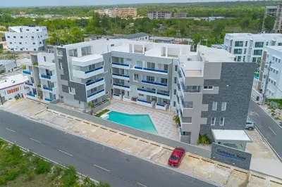 an overhead view of a large apartment building with a pool at Caribbean Getaway 2BR at Caribbean Rose Bayahibe in San Rafael del Yuma