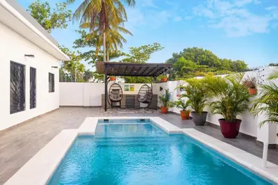 a swimming pool in the backyard of a house at SwellHouseVilla in Cabrera