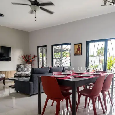 a living room with a table and chairs and a couch at SwellHouseVilla in Cabrera