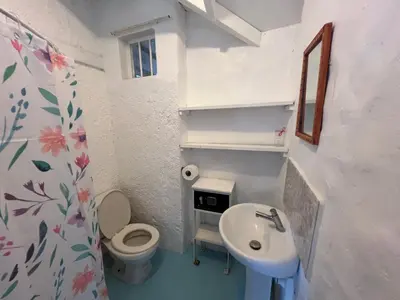 a small bathroom with a toilet and a sink at Hostel La Bohème in Las Terrenas