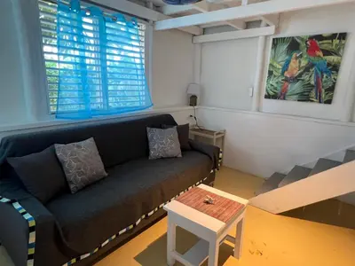 a living room with a couch and a table at Hostel La Bohème in Las Terrenas