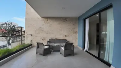 a patio with two chairs and a table on a balcony at Cigua Palmera 42 in Puerto Plata