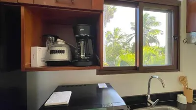 a kitchen counter with a coffee maker and a window at Hideaway Studio - steps from Playa Encuentro at Cabarete in Cabarete