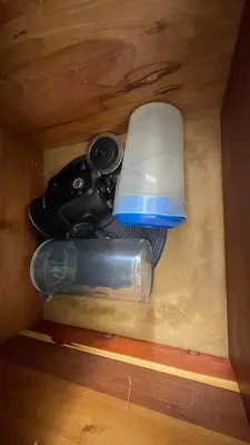 a flashlight and a camera in a wooden box at Hideaway Studio - steps from Playa Encuentro at Cabarete in Cabarete