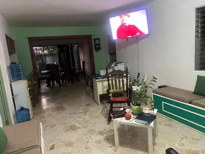 a living room with a flat screen tv on the wall at FredyGreenHouse in Santiago de los Caballeros