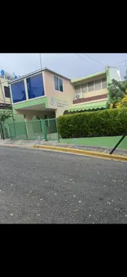 a house with a fence in front of a street at FredyGreenHouse in Santiago de los Caballeros