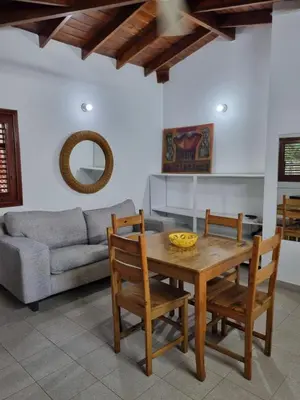 a dining room with a table and chairs and a couch at Sunset Paradise in Las Terrenas