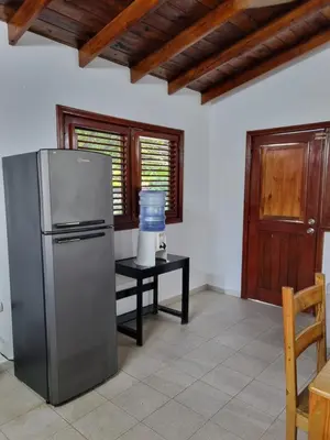 a kitchen with a refrigerator and a table at Sunset Paradise in Las Terrenas