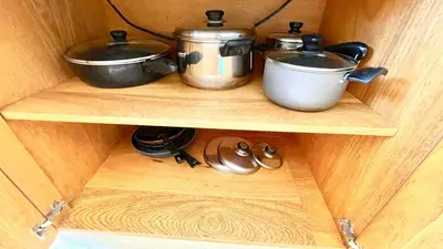 two pots and pans on a shelf in a cabinet at Luxury 2BR Villa - Beach Access and Elegant Design at Cabarete in Cabarete