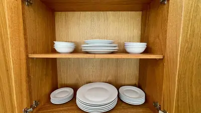 a cabinet with plates and bowls on a shelf at Luxury 2BR Villa - Beach Access and Elegant Design at Cabarete in Cabarete