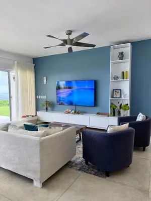 a living room with a couch and a flat screen tv at Casa Amalfi Luxury Oceanview Villa with Pool in Cabrera