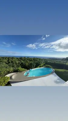 two pictures of a pool of water in a field at Casa Amalfi Luxury Oceanview Villa with Pool in Cabrera