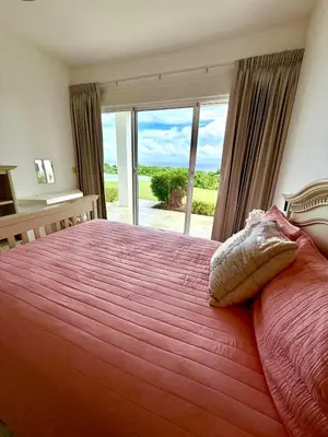a bedroom with a large bed with a large window at Casa Amalfi Luxury Oceanview Villa with Pool in Cabrera
