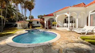 a swimming pool in front of a house at 2BR villa & 1BR Guest House, Pool and Beach at Playa Encuentro, Cabarete in Cabarete