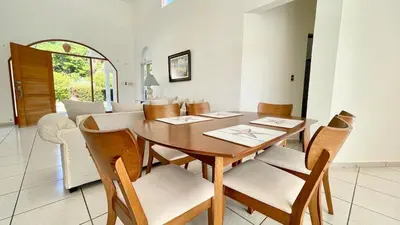 a dining room with a wooden table and chairs at 2BR villa & 1BR Guest House, Pool and Beach at Playa Encuentro, Cabarete in Cabarete