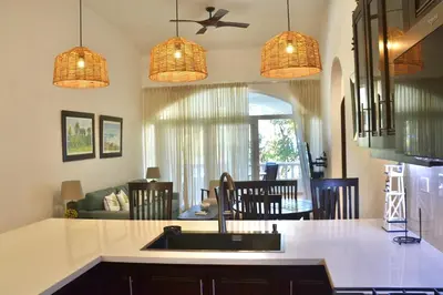 a kitchen with a sink and a living room at Beachfront Hideaway 2BR Apartment at Playa Encuentro, Cabarete in Cabarete
