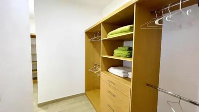 a walk in closet with wooden shelves and towels at 3BR Hideaway Lux Villa With Pool & beach Access At Playa Encuentro, Cabarete in Cabarete