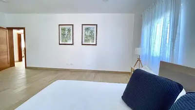 a white living room with two pictures on the wall at 3BR Hideaway Lux Villa With Pool & beach Access At Playa Encuentro, Cabarete in Cabarete