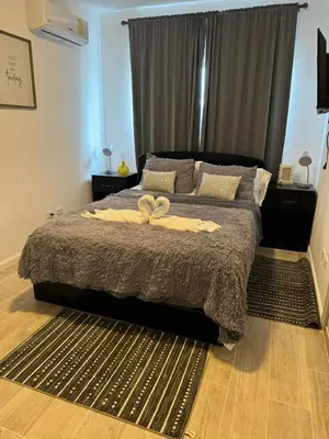 a bedroom with a bed with two towels on it at Apartamento Luxury Punta Cana in Punta Cana