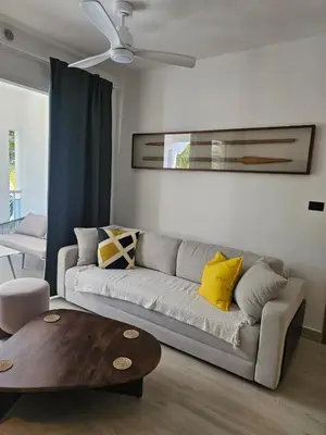 a living room with a couch and a coffee table at Estrella Garden Antlia 201 Modern Apartment in La Laguna