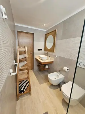 a bathroom with a sink and a toilet and a mirror at Estrella Garden Antlia 201 Modern Apartment in La Laguna