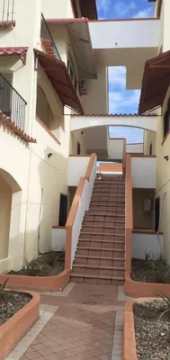 a stairway leading up to a building with stairs at Palm Beach Resort in Boca Chica