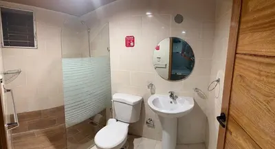 a bathroom with a toilet and a sink at Filadelfia II in La Grúa