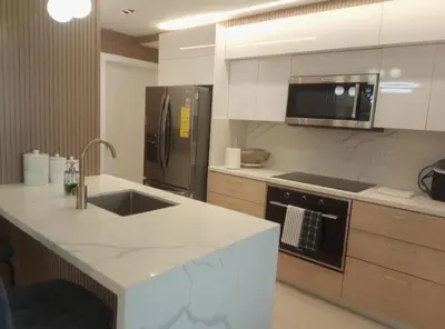 a kitchen with a stainless steel refrigerator and a sink at Torre Sky 01 M10-2 in Santo Domingo