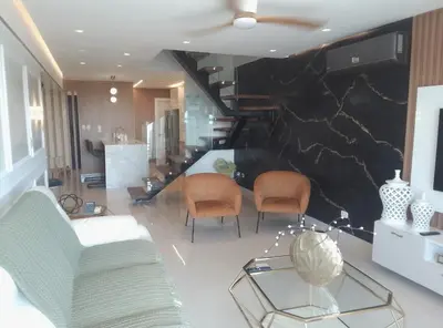 a living room with two chairs and a staircase at Torre Sky 01 M10-2 in Santo Domingo