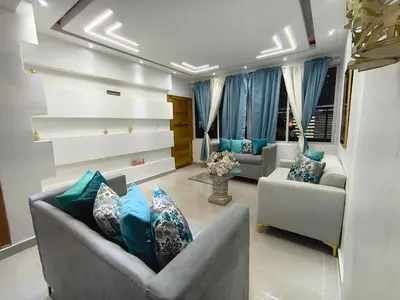 a living room with two couches and blue pillows at América Colares VII in Los Frailes