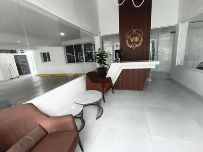a lobby with a bar with chairs and a table at América Colares VII in Los Frailes