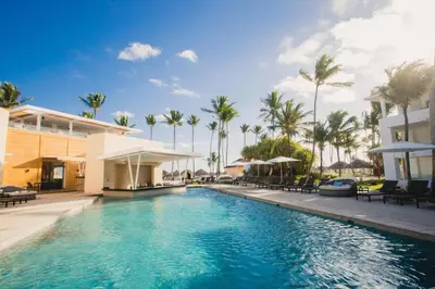 a pool at a resort with palm trees at Caribe Deluxe Princess - All Inclusive in Punta Cana