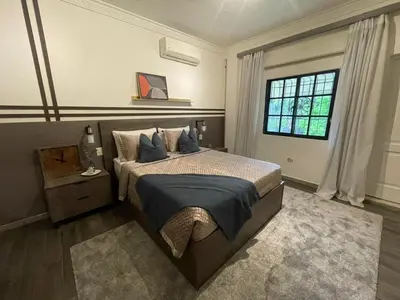 a bedroom with a large bed and a window at Estancia Azul by Fusion Market in Santo Domingo