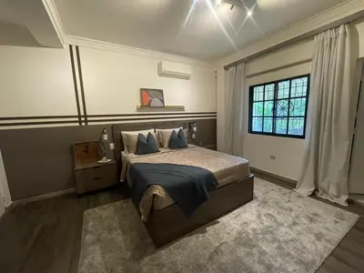 a bedroom with a bed and a window at Estancia Azul by Fusion Market in Santo Domingo