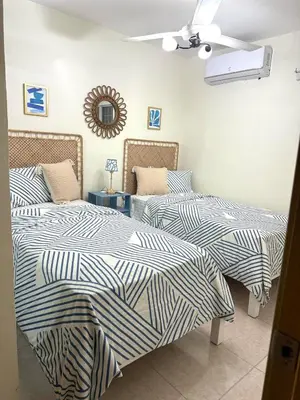 two beds sitting next to each other in a bedroom at Modern Penthouse Style Apt in Licey al Medio