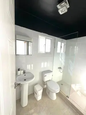 a bathroom with a toilet and a sink and a shower at Modern Penthouse Style Apt in Licey al Medio