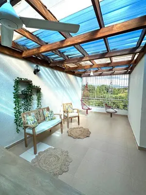 a living room with two chairs and a swing at Modern Penthouse Style Apt in Licey al Medio