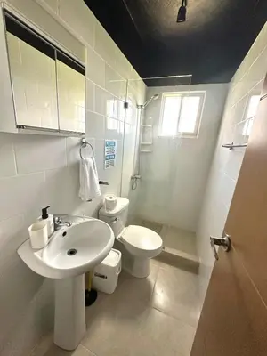 a white bathroom with a toilet and a sink at Modern Penthouse Style Apt in Licey al Medio