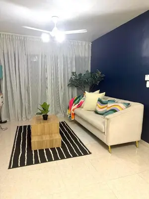 a living room with a couch and a blue wall at Modern Penthouse Style Apt in Licey al Medio