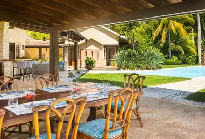 a wooden table and chairs on a patio at Villa Maji Luxury Private Villa Steps from the Ocean Sea Horse Ranch Cabarete in Cabarete