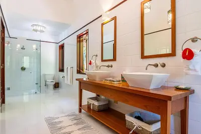 a bathroom with two sinks on a wooden counter at Villa Maji Luxury Private Villa Steps from the Ocean Sea Horse Ranch Cabarete in Cabarete