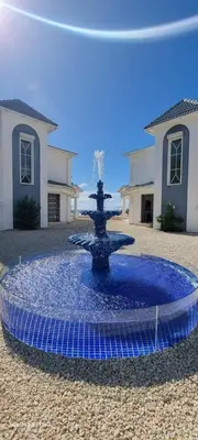 a blue fountain in the middle of a courtyard at Villas Caribe in Juan Dolio