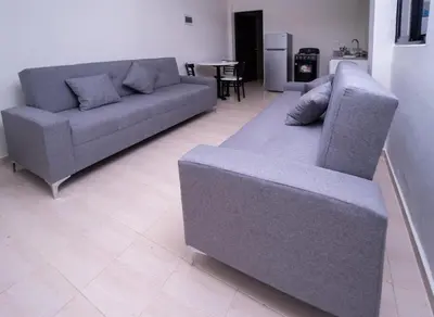 a living room with two couches and a table at Hotel Porto Escondido in Santa Bárbara de Samaná
