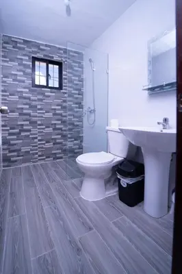 a bathroom with a toilet and a sink at Hotel Porto Escondido in Santa Bárbara de Samaná