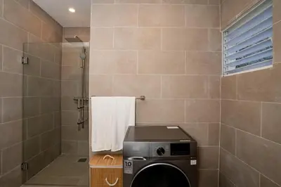 a bathroom with a washing machine in a shower at Las Terranas Dream Condo in Las Terrenas