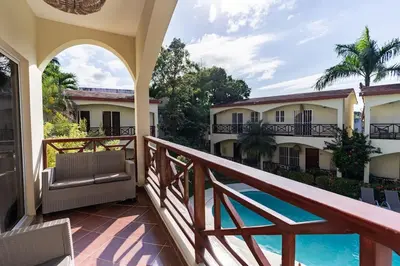 a balcony with a view of the pool at Las Terranas Dream Condo in Las Terrenas