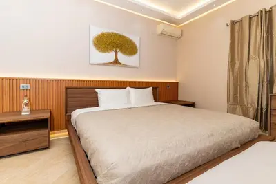 a bedroom with a bed and a tree painting on the wall at Las Terranas Dream Condo in Las Terrenas