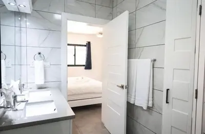 a white bathroom with a sink and a mirror at Bonita Extravaganza 4 Bedroom, 4 Bed, 3 Bedroom in Sosúa