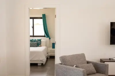 a living room with a bed and a chair at Bonita Extravaganza 4 Bedroom, 4 Bed, 3 Bedroom in Sosúa